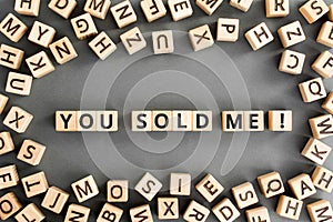 You sold me - phrase from wooden blocks with letters