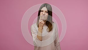 You tell lie! Brunette young woman touching nose and frowning displeased, angry about deception