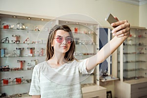 You think I should buy glasses or not. Portrait of glamourous attractive woman on shopping standing in optician store