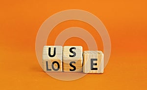 You use or lose it symbol. Concept word Use or lose on wooden cubes. Beautiful orange table orange background. Business and you