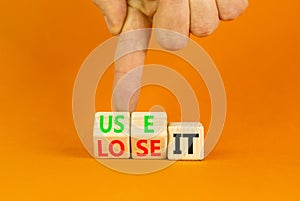 You use or lose it symbol. Concept word Use It or lose it on wooden cubes. Beautiful orange table orange background. Businessman