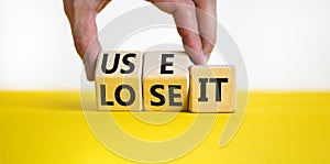 You use or lose it symbol. Concept word Use It or lose it on wooden cubes. Beautiful yellow table white background. Businessman