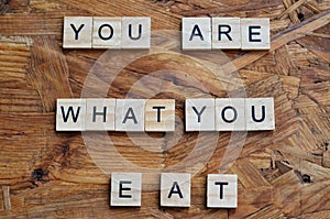 you are what you eat text on wooden square, motivation quotes