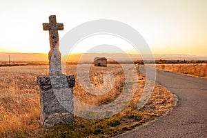 Highlighted cross memorial monument along the side of the road