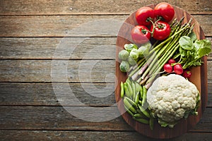 You wont find anything fresher. a variety of fresh produce on a wooden chopping board.