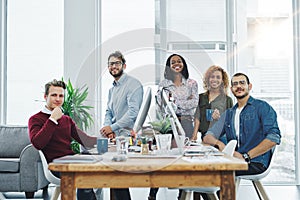 You wont find a more hardworking team. Portrait of a team of young go getters working in a modern office.