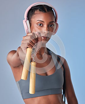 You wont regret working out with this. Studio shot of a fit young woman working out with jump rope against a grey