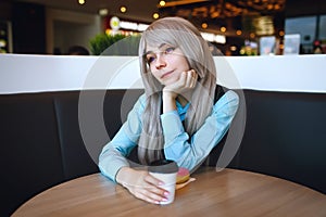 Youbg atteractive girl at cafe at the table alone