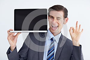 Youd be doing yourself a favor by getting this. Laptop, wink and perfect sign by man portrait with mockup or space for