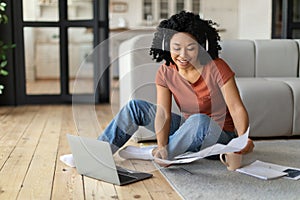 Youg Black Freelancer Woman Working With Laptop And Papers At Home