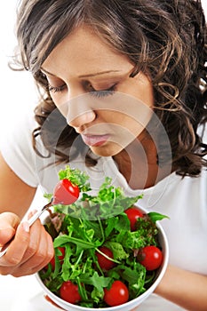 Youg woman eating healthy salad