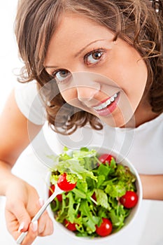 Youg woman eating healthy salad