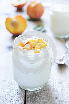 Yougurt with peaches slice. Selective focus