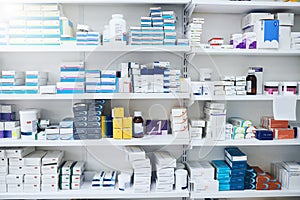 Youll find something to make you better here. shelves stocked with various medicinal products in a pharmacy.
