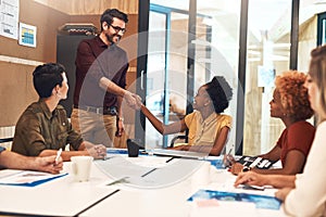 Youll fit in perfectly with our team. businesspeople shaking hands during a meeting in an office.