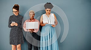 Youll need to byod to join them. Studio shot of a group of attractive young businesswomen using wireless technology