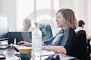 Yound devoted female software developers team working on desktop computer in IT statup company.