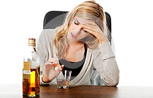 Yound woman in depression, drinking alcohol