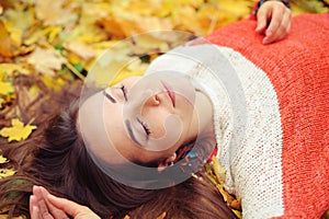 Yound woman relax with closed eyes in autumn park