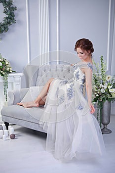 Yound woman relaxing on blue sofa