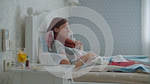 Young 30s woman blowing her nose with napkin and using inhaler for therapy of disease like flu or respiratory viruses at