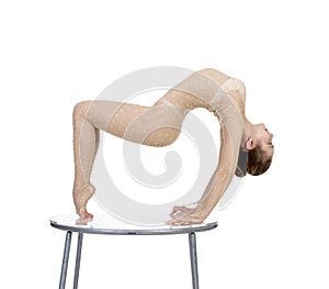 Young acrobat, circus actress in a suit with rhinestones