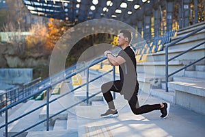 Young active asian fit man engaged in physical exercise stretching outdoor street. Male athlete in sportswear workout urban city