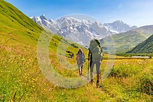 Young active girls hiking in Greater Caucasus mountains, Mestia district, Svaneti, Georgia