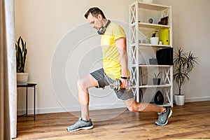 Young active guy doing lower body workout at home