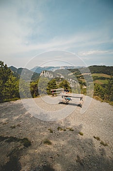 Young active hiker rests on a rest area and reads a book overlooking the Kalte Rinne viaduct in Styria, northeastern Austria