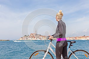 Young active woman cycling round Rovinj, Istria, Croatia.