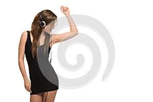 Young active woman listening to music from headphones