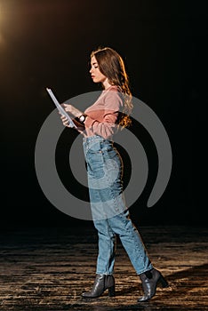 Young actress reading scenario on stage
