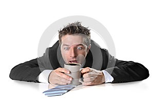 Young addict business man holding cup of coffee crazy in caffeine addiction