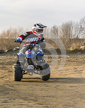 Young adept steering training a ride on a small quad.