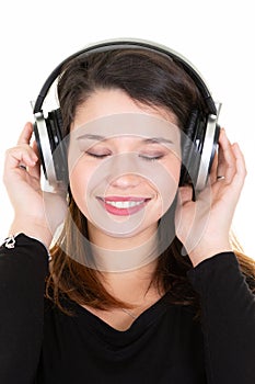 Young adorable fresh looking brunette woman with closed eyes long brown hair posing in big professional dj headphone