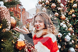 Young and adorable russian girl walking on Manezhnaya Square Moscow on the Red Square through winter holiday