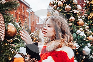 Young and adorable russian girl walking on Manezhnaya Square Moscow on the Red Square through winter holiday
