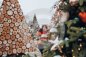 Young and adorable russian girl walking on Manezhnaya Square Moscow on the Red Square through winter holiday