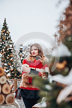 Young and adorable russian girl walking on Manezhnaya Square Moscow on the Red Square through winter holiday