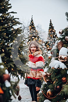 Young and adorable russian girl walking on Manezhnaya Square Moscow on the Red Square through winter holiday