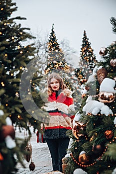 Young and adorable russian girl walking on Manezhnaya Square Moscow on the Red Square through winter holiday