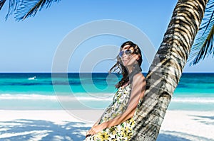 Young adorable woman at tropical sandy beach during Caribbean vacation