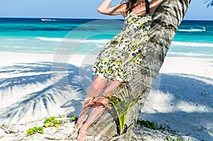 Young adorable woman at tropical sandy beach during Caribbean vacation