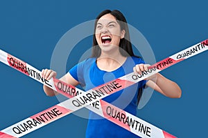 Young adult asian girl screaming, standing behind caution line