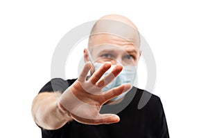 Young adult bald head man wearing respiratory protective medical mask