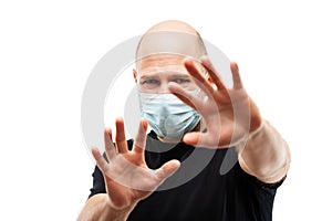 Young adult bald head man wearing respiratory protective medical mask