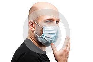 Young adult bald head man wearing respiratory protective medical mask