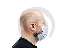 Young adult bald head man wearing respiratory protective medical mask