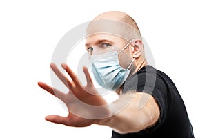 Young adult bald head man wearing respiratory protective medical mask